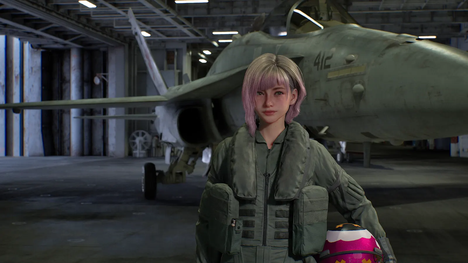 Tasha in flight gear beside an aircraft inside a hangar